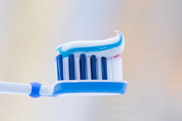 Toothbrush with toothpaste on blurred background