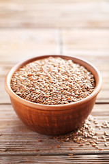 Brown flax seeds on a wooden table