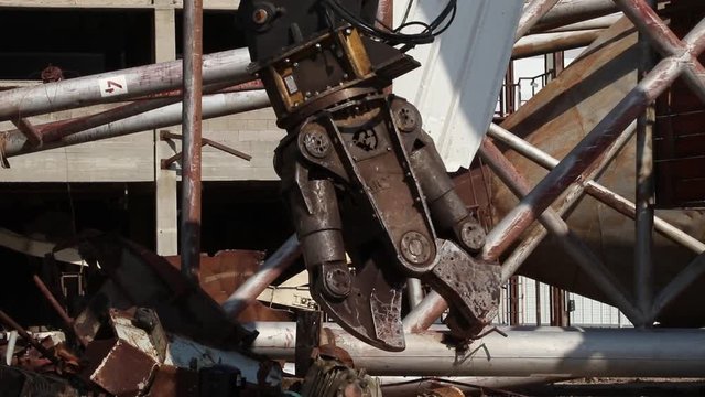 Bulldozer destroy rusty metal construction