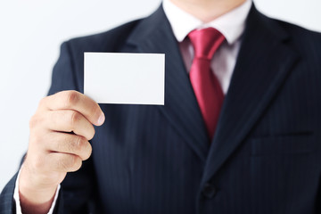 Businessman holding blank card in his hand