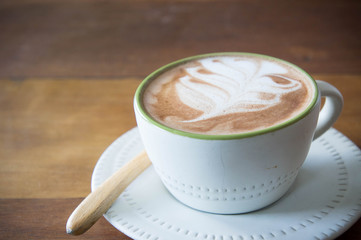 coffee cup and strawberry cake in coffee shop  with wood backgro