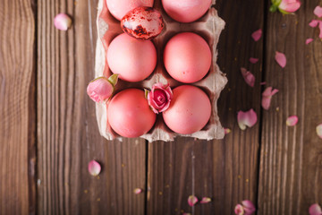Pink Easter eggs on wodden background. Copyspace. Still life photo of lots of pink easter eggs.Background with easter eggs. Pink eggs and roses. Easter photo concept