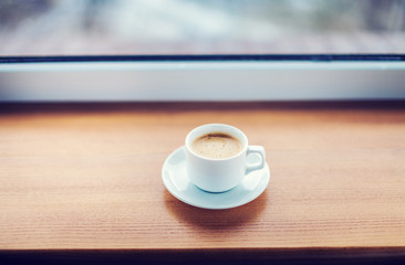 Cup of coffee on a wooden table.