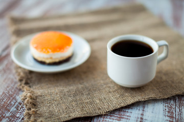 orange pastry in a dish is isolated on a wooden background