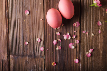 Pink Easter eggs on wodden background. Copyspace. Still life photo of lots of pink easter eggs.Background with easter eggs. Pink eggs and roses. Easter photo concept