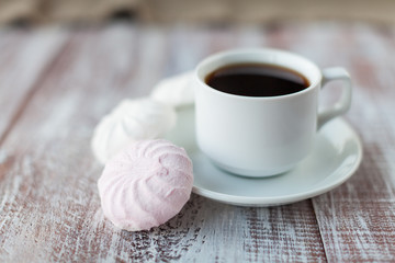 Cup of coffee, cookies, walnut and chocolate on the white wooden