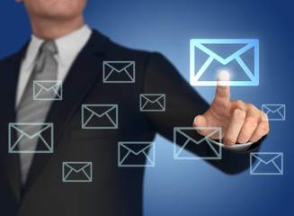 Businessman pressing mail icon 
