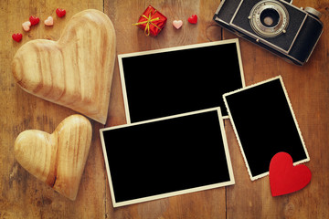 empty photo frames next to old camera and hearts