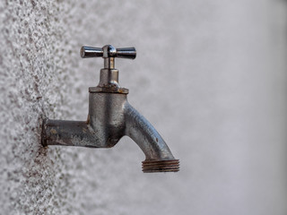 Outside tap on white wall