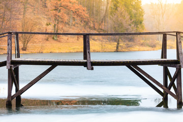 Old, wooden, small bridge on frozen lake