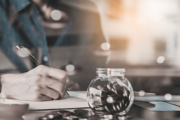 Close up of people hand work calculator and money,coins in finan