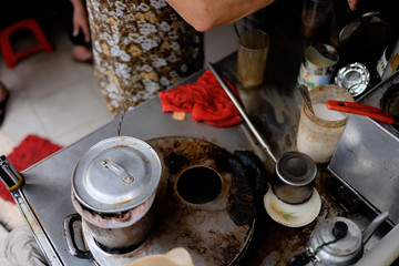 Phan Dinh Phung street, Ho Chi Minh city, Viet Nam - FEB 7: Unidentified woman with private business at home by cafe store. Coffee is favorite drink at Vietnam