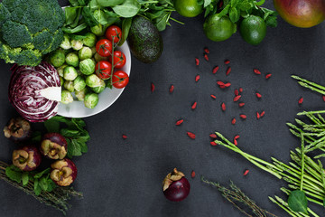 Fresh green farm produce top view on dark color