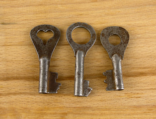 Old keys on a wooden board