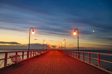 Deurstickers Pier pier overlooking the sea after sunset