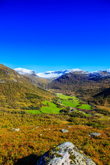  Great landscape with fall colors and new snow on the mountain tops, in western Norway