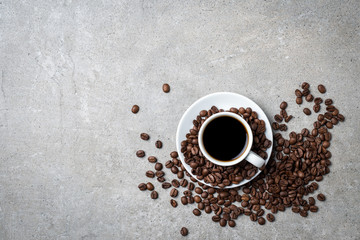Cup of coffee with coffee beans on gray stone background. Top view - 135346058