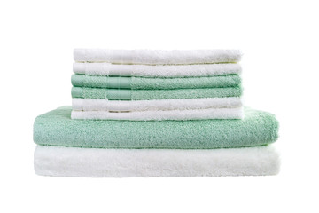 Stack of white and green bath towels isolated over white background
