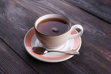 cup of black tea on a wooden table