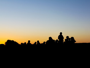 Fototapeta na wymiar People silhouette against sunset