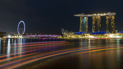 Fototapeta premium night time cityscape of Singapore with light reflections in the water - built on reclaimed land