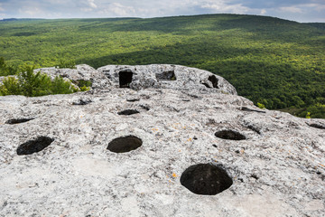 Entrance to the cave on top of the mountain, view of the forest