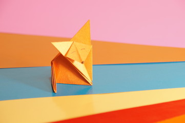 
Paper origami fox isolated on a colorful background