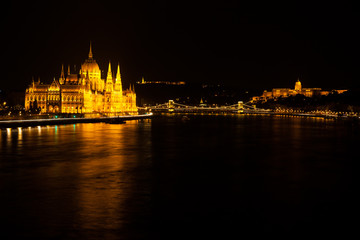 Hungarian Parliament Building located at the bank of the Dunabe river with famous Chain Bridge connecting Buda and Pest in Budapest, Hungary