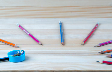 Obraz premium Pencil sharpener shavings on a wooden table. Back to school
