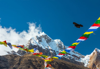 Majestic Mountain View with Buddhist Prayer Flags and Bird