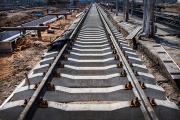Fototapeta na wymiar Concrete railroad ties in railway construction site. Perspective view