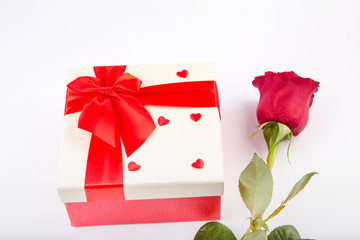gift box and rose on a light background.