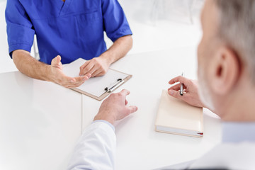 Professional doctors communicating at desk