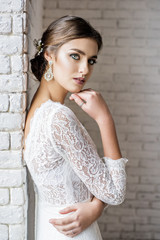 Fototapeta premium Modern bride in vintage dress with a wedding bouquet in hands