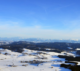 Fototapeta na wymiar Aerial view of snowy south germany with Alps on a sunny winter day
