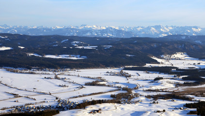Aerial view  of snowy south germany with Alps on a sunny winter day