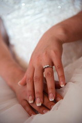 Obraz na płótnie Canvas Bride hands on wedding dress