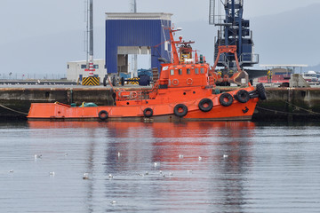 Fototapeta premium orange tug on the dock