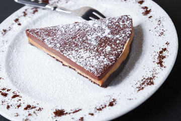 Chocolate tart slice sprinkle with powdered sugar