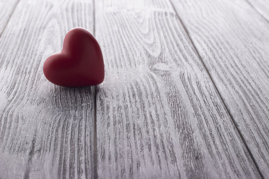 Red Heart on the white painted wooden background