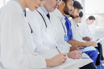 Fototapeta premium Pensive medical team making notes at clinic