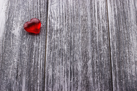 Red Heart on the gray painted wooden background