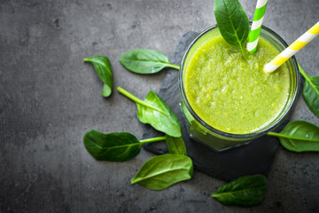 Healthy green spinach smoothie in glass. Clean eating and healthy food.