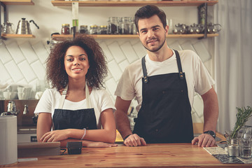 Cheerful coffee shop partners are situating near cash desk