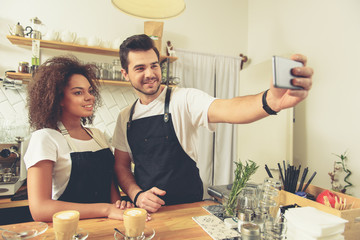Outgoing waiters making photo on mobile phone