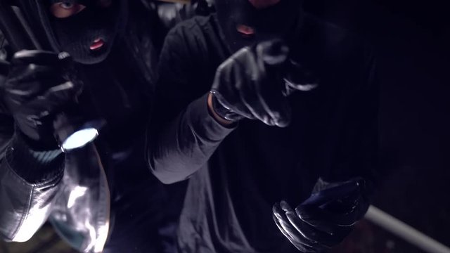 masked burglars breaking and entering into a victim's home