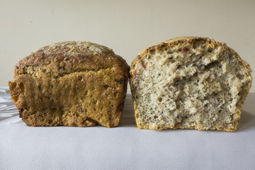 Two piece of homemade bread with cranberries . The Polish kitchen. Brown bread made from rye on a light background. .