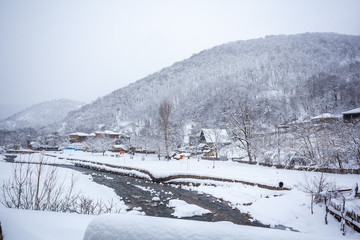 village covered with snow on the pass Rikota, Georgia
