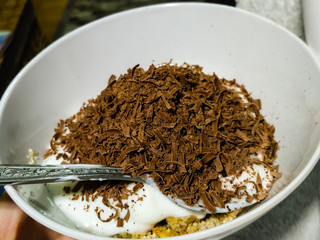 Tasty homemade yogurt with grated chocolate and musli