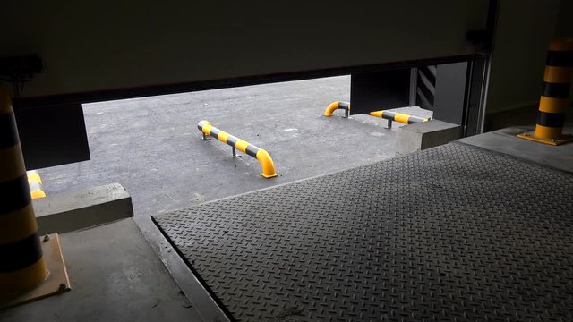 Loading technology in the Industrial warehouse. Sectional garage door &  Hydraulic Dock Leveller systems.